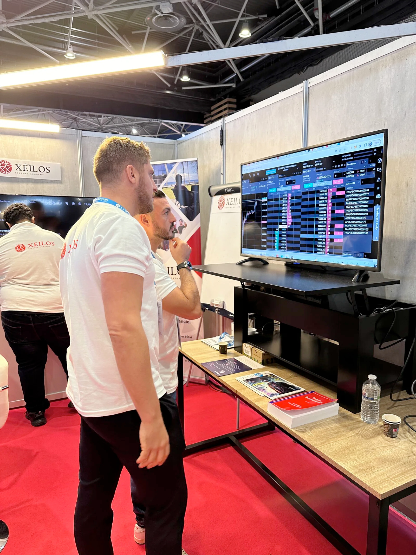 Xeilos Trading School team at conference booth